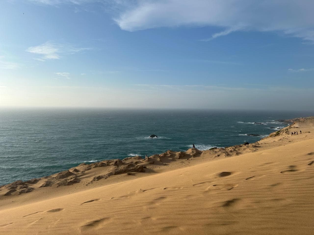Golden sand dunes meeting the Atlantic Ocean on the coastal trip